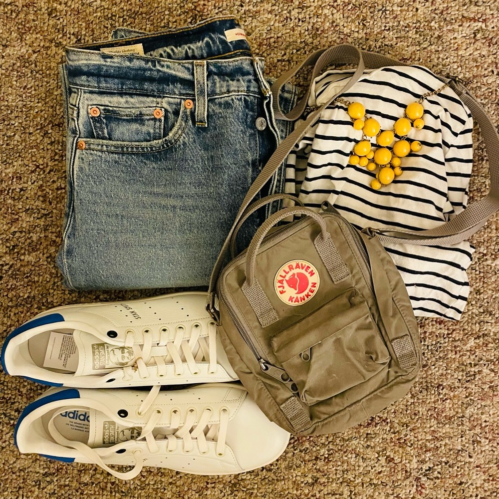 Small gray Fjallraven Kanken sling shoulder bag